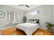 Cozy bedroom featuring a minimalist design, hardwood floors, and ample natural light at 1011 Westbrook Dr # A, Charlotte, NC 28202
