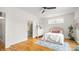 Bright bedroom featuring wood floors, a plush bed, neutral walls, and access to a well-lit bathroom at 1011 Westbrook Dr # A, Charlotte, NC 28202