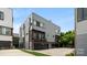 Modern gray home featuring a two-car garage, balcony, and clean architectural lines at 1011 Westbrook Dr # A, Charlotte, NC 28202