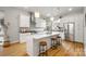 Modern kitchen featuring white cabinetry, marble countertops, stainless steel appliances, and island seating at 1011 Westbrook Dr # A, Charlotte, NC 28202