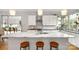 Beautiful kitchen island features marble countertops, stylish stools, and modern fixtures at 1011 Westbrook Dr # A, Charlotte, NC 28202