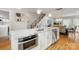 Modern kitchen with marble island, stainless appliances, and staircase view, ready for cooking at 1011 Westbrook Dr # A, Charlotte, NC 28202