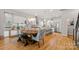 Open concept kitchen and dining area with modern lighting, appliances, and stylish seating at 1011 Westbrook Dr # A, Charlotte, NC 28202