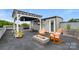Cozy rooftop deck with fire pit, comfortable seating, pergola, and a stylish outdoor retreat at 1011 Westbrook Dr # A, Charlotte, NC 28202
