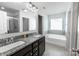 Modern bathroom features granite countertop, double vanity, bathtub and glass shower at 1019 Beacon Ave, Monroe, NC 28110
