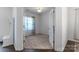 Carpeted bedroom with an open doorway, with a window with patterned curtains at 1019 Beacon Ave, Monroe, NC 28110