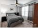 Bedroom with gray bedding, a ceiling fan and an abundance of natural light at 1019 Beacon Ave, Monroe, NC 28110