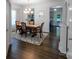 Formal dining room boasts wood floors, decorative rug, chandelier and ample seating at 1019 Beacon Ave, Monroe, NC 28110