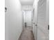 White hallway leads to other rooms and features two closet spaces at 1019 Beacon Ave, Monroe, NC 28110