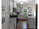 Modern kitchen featuring gray cabinets, granite countertops, stainless steel appliances, and center island at 1019 Beacon Ave, Monroe, NC 28110