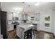 Bright kitchen featuring gray cabinets, granite countertops, stainless steel appliances, and island seating at 1019 Beacon Ave, Monroe, NC 28110