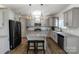 Kitchen featuring gray cabinets, granite countertops, stainless steel appliances, and center island at 1019 Beacon Ave, Monroe, NC 28110
