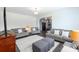 Cozy living room features neutral walls, grey couches, ottoman and a view of the kitchen at 1019 Beacon Ave, Monroe, NC 28110
