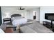 Spacious main bedroom features large windows, ceiling fan, TV and ensuite bathroom at 1019 Beacon Ave, Monroe, NC 28110