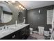 Bathroom with dual vanity, dark gray walls, modern fixtures, and stylish decor at 10925 Lassen Ct, Charlotte, NC 28214