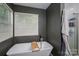 Modern bathroom featuring a freestanding tub under a window, creating a bright and inviting space at 10925 Lassen Ct, Charlotte, NC 28214