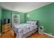 Cozy bedroom with hardwood floors, a double bed, and bright window at 10925 Lassen Ct, Charlotte, NC 28214