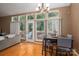 Dining room features large windows, hardwood floors, and access to the outdoor deck at 10925 Lassen Ct, Charlotte, NC 28214