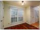 Bright, empty room with hardwood floors, a large window, and natural light offering versatile use at 10925 Lassen Ct, Charlotte, NC 28214