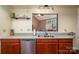 A bright kitchen offers modern countertops, stainless steel appliances, and open view to living area at 10925 Lassen Ct, Charlotte, NC 28214