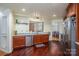 Well-lit kitchen features stainless steel appliances, wood cabinets, and open view to a dining area at 10925 Lassen Ct, Charlotte, NC 28214