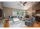Inviting living room with a comfortable gray sectional, high ceilings, wood floors, and natural light at 10925 Lassen Ct, Charlotte, NC 28214