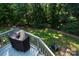 An inviting backyard with a deck, grill, fire pit, and lush greenery provides a relaxing outdoor space at 126 Doyle Farm Ln, Mooresville, NC 28115