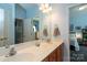 Bathroom with double sinks, a large mirror, and a view into the adjacent bedroom at 126 Doyle Farm Ln, Mooresville, NC 28115