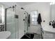 A modern bathroom offers great natural lighting and a sleek glass shower at 126 Doyle Farm Ln, Mooresville, NC 28115