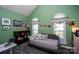 Bedroom featuring a daybed, green walls, arched windows, and vaulted ceiling at 126 Doyle Farm Ln, Mooresville, NC 28115