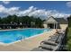 Community pool with blue water, lounge chairs and a pool house in the background at 126 Doyle Farm Ln, Mooresville, NC 28115