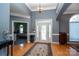 Grand foyer featuring hardwood floors, elegant chandelier and decorative glass door at 126 Doyle Farm Ln, Mooresville, NC 28115