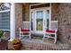 Inviting front porch with rocking chairs and decorative glass front door at 126 Doyle Farm Ln, Mooresville, NC 28115