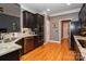 Modern kitchen with dark cabinets, stainless steel appliances, and hardwood floors at 126 Doyle Farm Ln, Mooresville, NC 28115