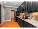 Well-equipped kitchen with black cabinetry, stainless steel appliances, and granite countertops at 126 Doyle Farm Ln, Mooresville, NC 28115