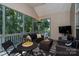 Inviting screened-in porch with comfortable seating, a TV, and serene views at 126 Doyle Farm Ln, Mooresville, NC 28115