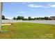 A large backyard with green grass and a white fence at 128 Cherry Birch St, Mooresville, NC 28117
