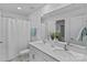 Bathroom showcasing double sinks, white cabinets, and a shower with curtain at 128 Cherry Birch St, Mooresville, NC 28117