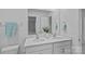 Bathroom featuring double sinks with white cabinets and a large mirror at 128 Cherry Birch St, Mooresville, NC 28117
