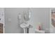 Elegant powder room with pedestal sink, oval mirror, and neutral decor at 128 Cherry Birch St, Mooresville, NC 28117
