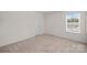 A bright bedroom with neutral walls and carpet at 128 Cherry Birch St, Mooresville, NC 28117