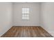 A blank slate room with hardwood flooring and a window at 128 Cherry Birch St, Mooresville, NC 28117
