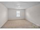 Unfurnished carpeted room with a window at 128 Cherry Birch St, Mooresville, NC 28117