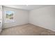 A minimalist bedroom with neutral carpet and a single window at 128 Cherry Birch St, Mooresville, NC 28117