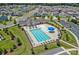 Aerial view of a community pool with lounge chairs, umbrellas, and manicured landscaping at 128 Cherry Birch St, Mooresville, NC 28117