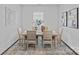 Inviting dining room with neutral tones, a wooden table set for six, and elegant decor for Gathering meals at 128 Cherry Birch St, Mooresville, NC 28117
