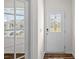 Bright entry featuring a window, wood-look flooring and a decorative front door at 128 Cherry Birch St, Mooresville, NC 28117