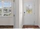 Bright foyer featuring a window, wood-look flooring and a decorative front door at 128 Cherry Birch St, Mooresville, NC 28117