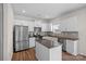 Modern kitchen featuring white cabinets, stainless steel appliances, and a central island at 128 Cherry Birch St, Mooresville, NC 28117