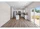 Bright kitchen with modern appliances and an adjacent outdoor dining area at 128 Cherry Birch St, Mooresville, NC 28117